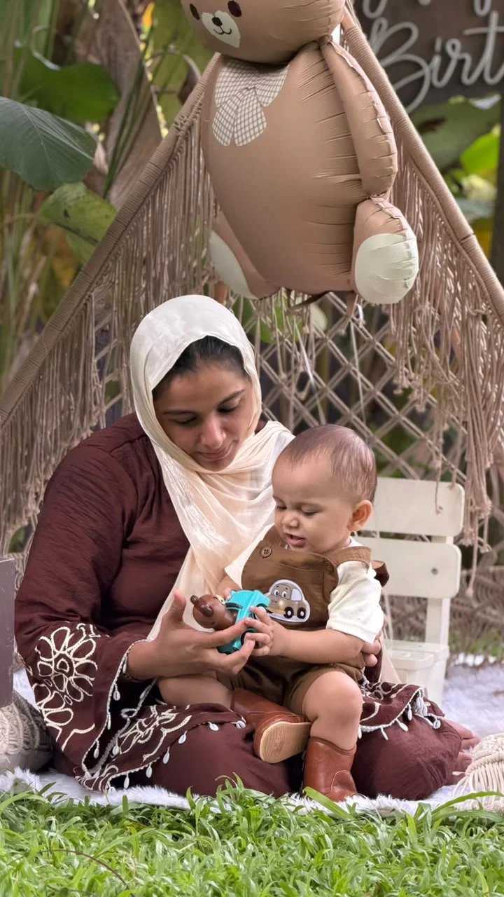 Mother and child exploring a small toy together