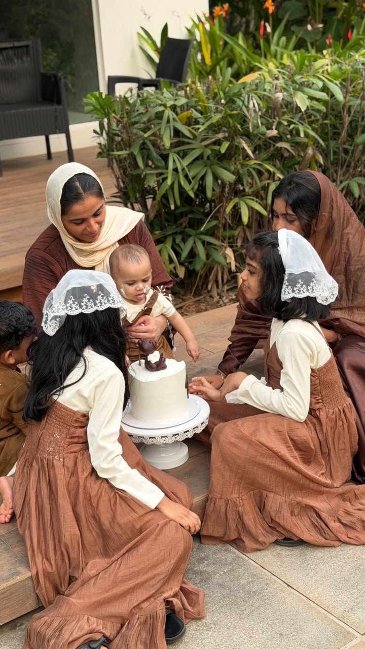 Family sharing a cake-cutting moment