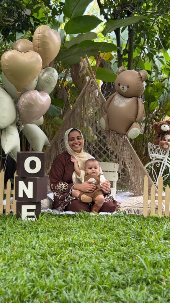 Mother and child seated together in a decorated garden
